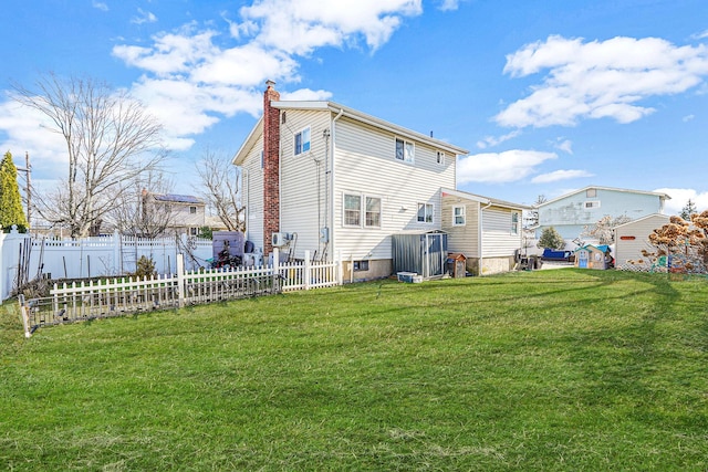 back of house with a lawn