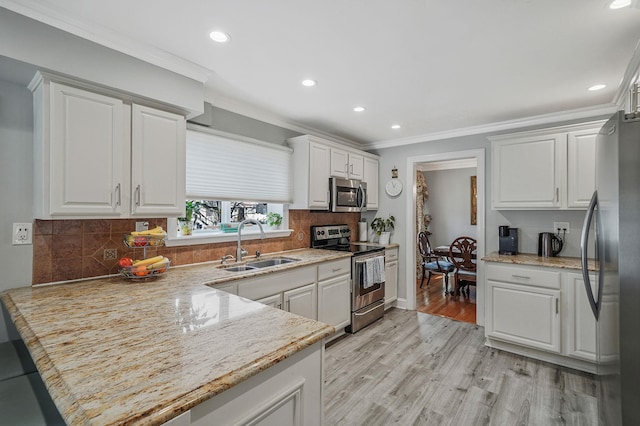 kitchen with white cabinetry, appliances with stainless steel finishes, sink, and light wood-type flooring