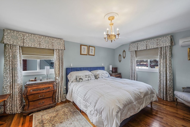 bedroom with vaulted ceiling, wood-type flooring, an AC wall unit, and an inviting chandelier