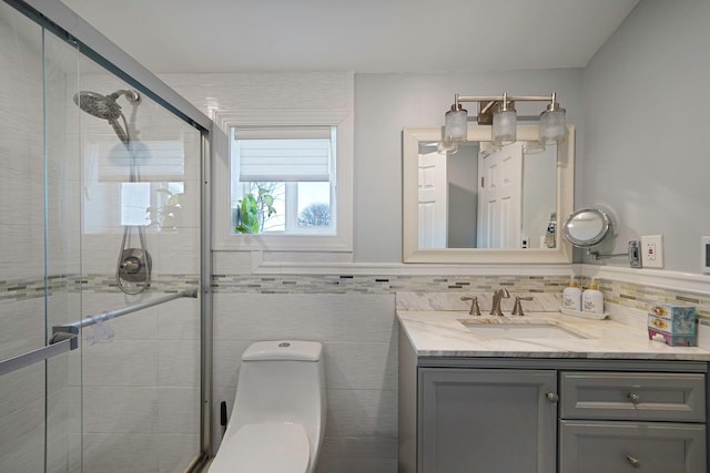 bathroom with vanity, a shower with door, and toilet