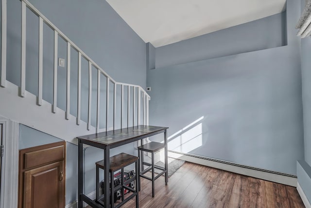 stairway featuring hardwood / wood-style flooring and a baseboard radiator