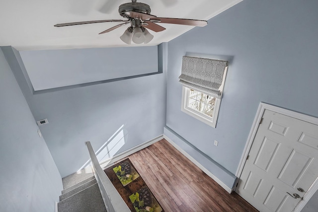 interior space with ceiling fan and dark hardwood / wood-style floors