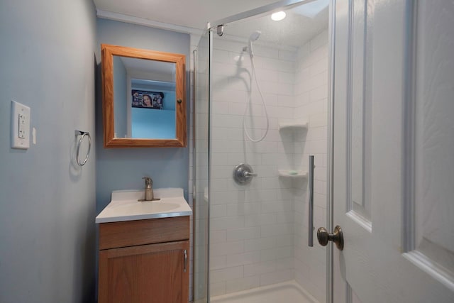 bathroom with a shower with door and vanity