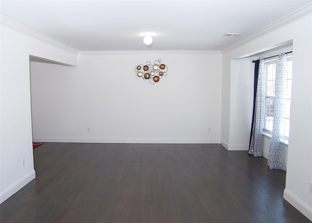 spare room featuring ornamental molding and dark hardwood / wood-style floors