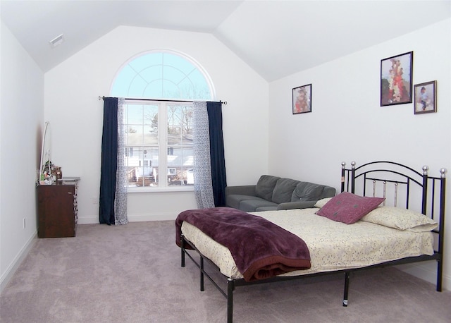 carpeted bedroom featuring vaulted ceiling