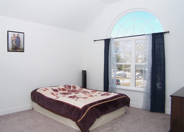 carpeted bedroom with vaulted ceiling