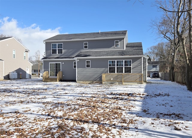 view of snow covered rear of property