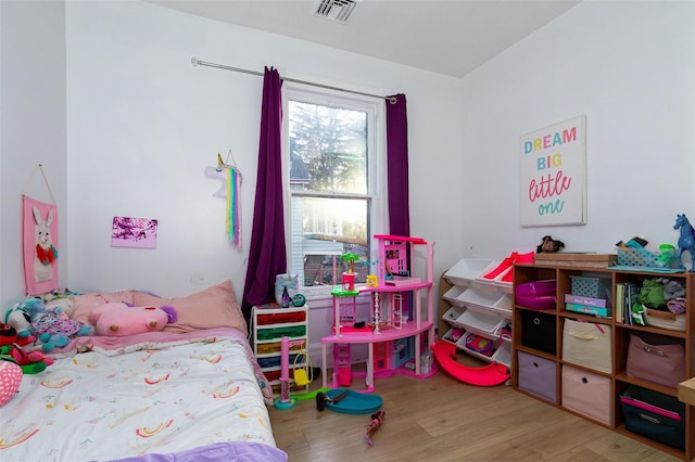 bedroom with hardwood / wood-style floors