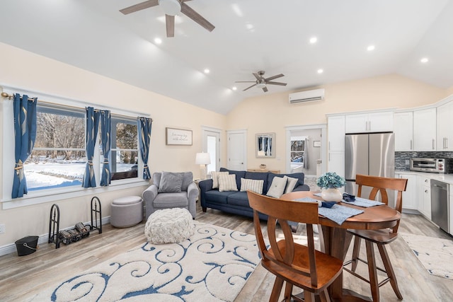 dining room featuring light wood finished floors, a toaster, a ceiling fan, and a wall mounted AC