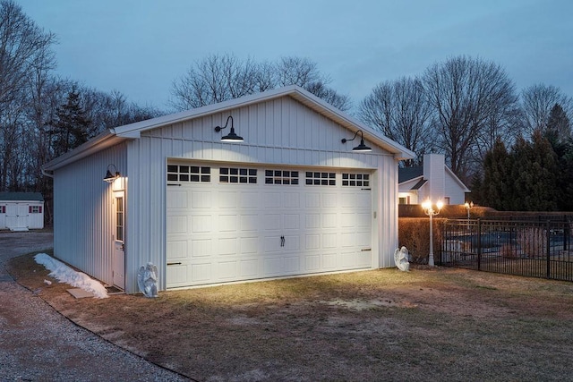 detached garage featuring fence