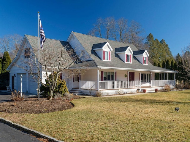 farmhouse inspired home with a garage, covered porch, and a front lawn