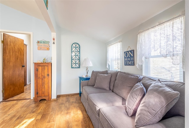 living room with vaulted ceiling and light hardwood / wood-style floors