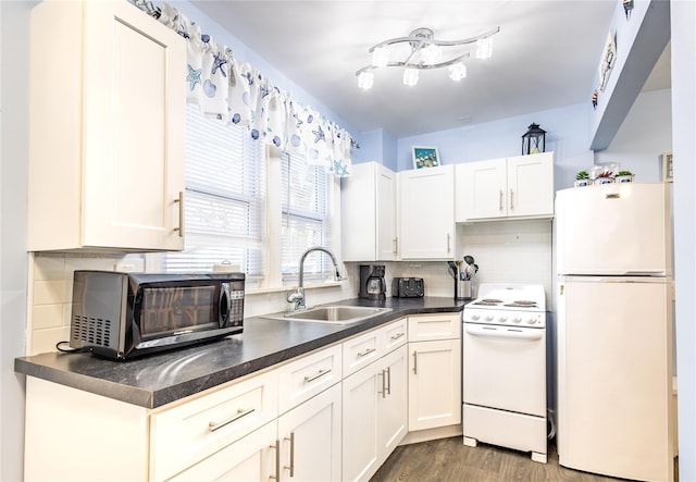 kitchen featuring sink, white appliances, decorative backsplash, and white cabinets