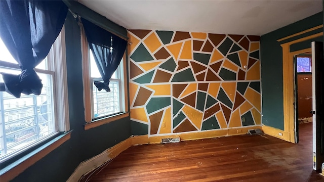 spare room with wood-type flooring