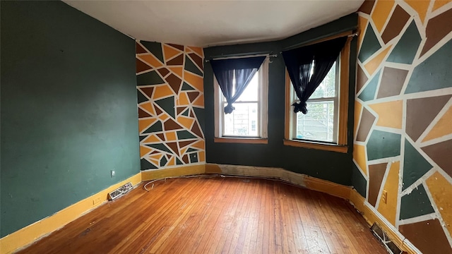 empty room with wood-type flooring