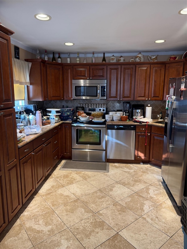 kitchen with light tile patterned floors, decorative backsplash, and stainless steel appliances