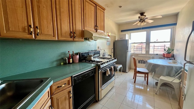 kitchen with sink, light tile patterned floors, stainless steel fridge, black dishwasher, and gas range oven