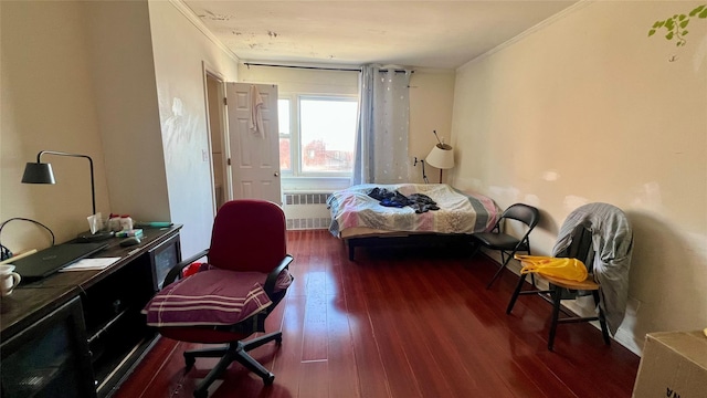 bedroom featuring dark hardwood / wood-style flooring, radiator, and crown molding