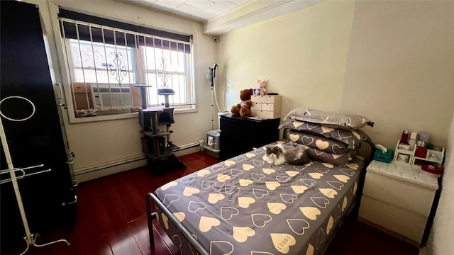 bedroom with a baseboard radiator, cooling unit, and dark hardwood / wood-style flooring