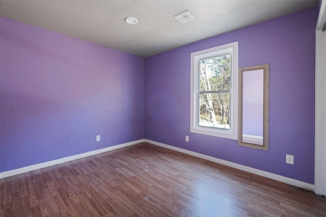 unfurnished room with hardwood / wood-style flooring