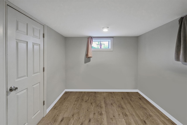 basement with light hardwood / wood-style flooring