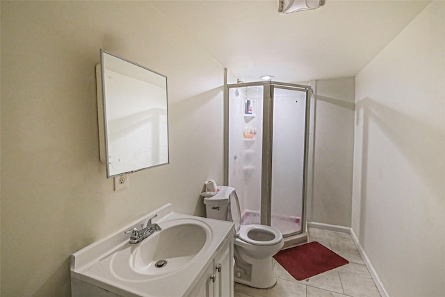 bathroom featuring tile patterned flooring, vanity, toilet, and walk in shower