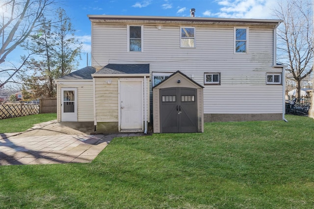 back of house featuring a storage shed, a patio, and a lawn