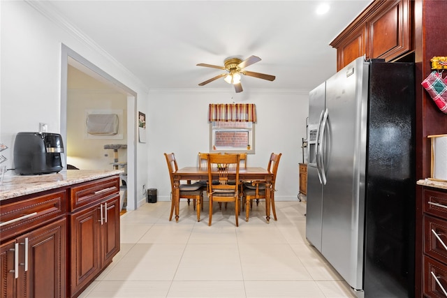 kitchen featuring light stone counters, light tile patterned floors, ornamental molding, and stainless steel refrigerator with ice dispenser