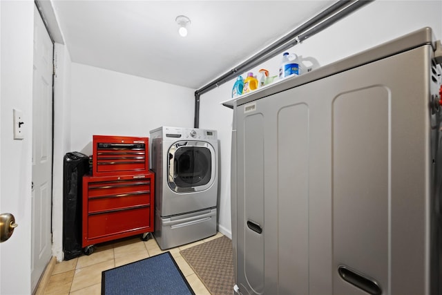 laundry area featuring separate washer and dryer and light tile patterned flooring