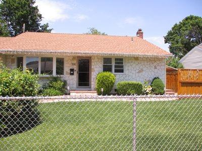 ranch-style home featuring a front yard