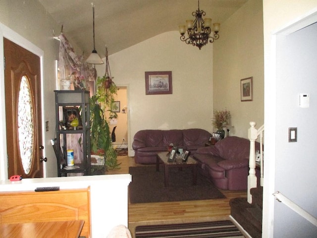 living room with an inviting chandelier, vaulted ceiling, and hardwood / wood-style floors