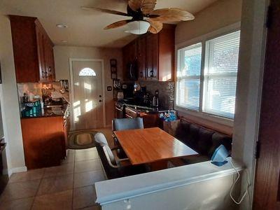 tiled dining space featuring ceiling fan