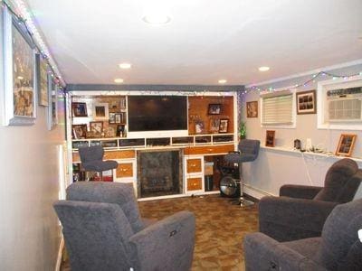 living room with an AC wall unit