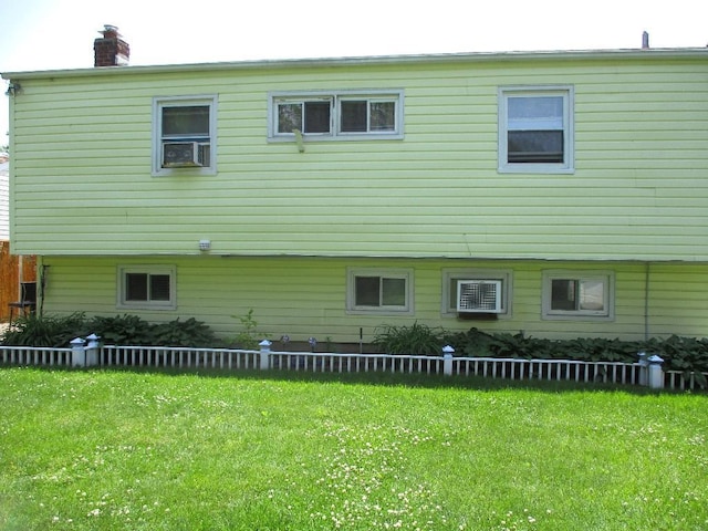 rear view of house with a yard