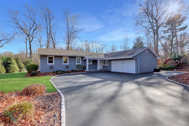 single story home with a garage and a front lawn