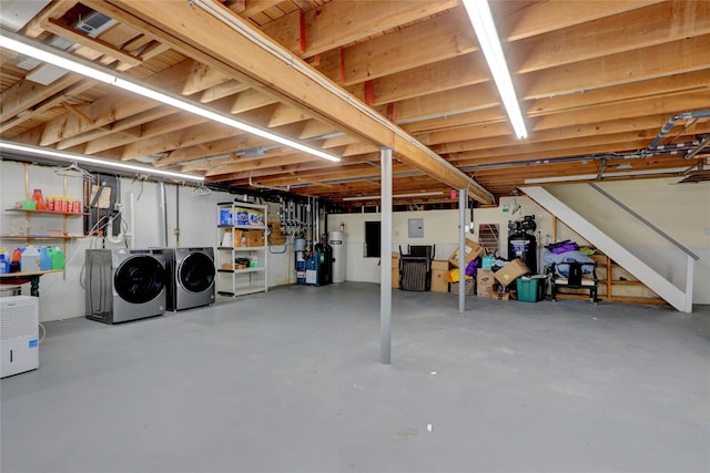 basement with washing machine and dryer and water heater