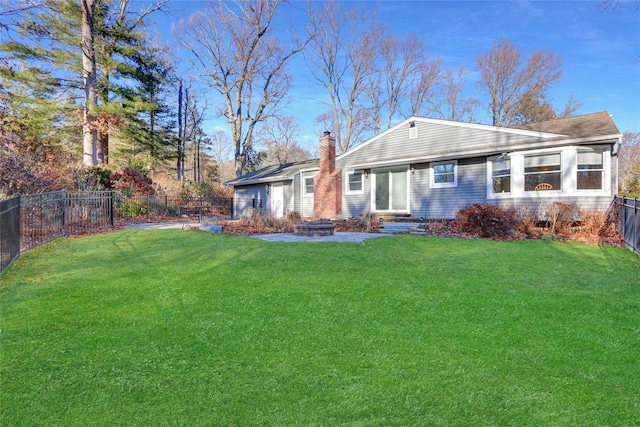 back of house featuring a lawn