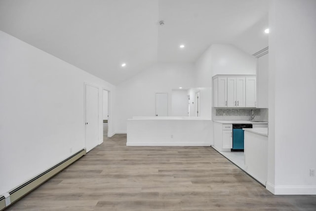 kitchen featuring baseboard heating, white cabinetry, light hardwood / wood-style floors, stainless steel dishwasher, and kitchen peninsula