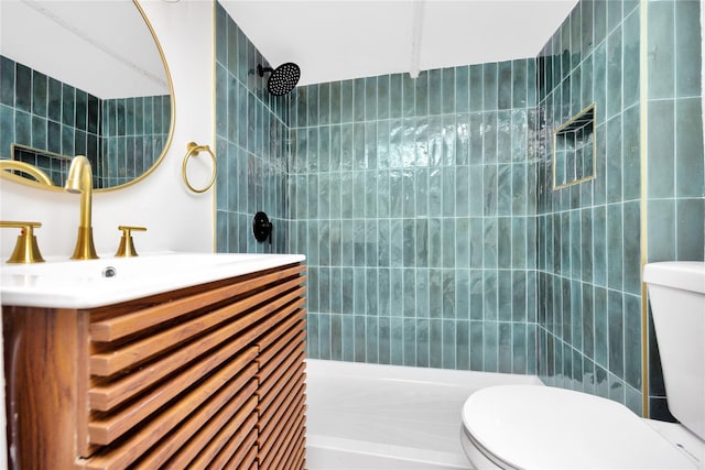 bathroom with vanity, toilet, and a tile shower