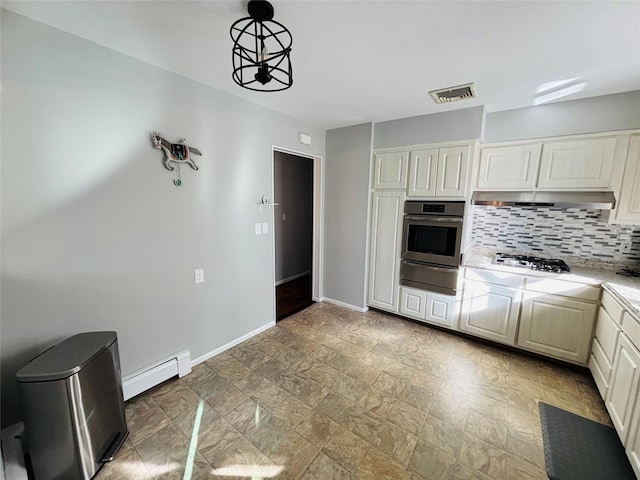 kitchen featuring baseboard heating, appliances with stainless steel finishes, decorative light fixtures, and backsplash