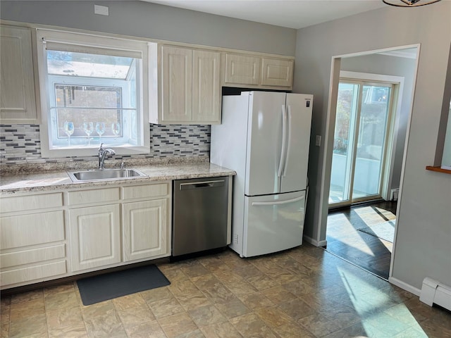 kitchen featuring dishwasher, white fridge, sink, and a healthy amount of sunlight