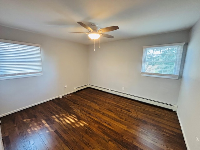 spare room featuring ceiling fan, dark hardwood / wood-style flooring, and a baseboard heating unit