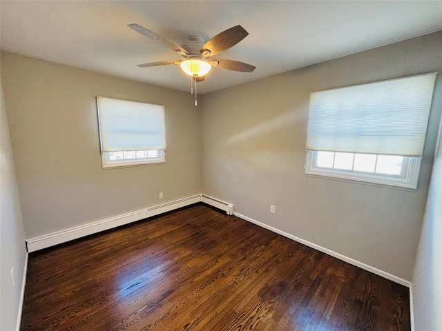 spare room with dark hardwood / wood-style flooring, ceiling fan, and baseboard heating