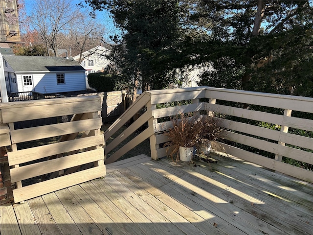 wooden terrace featuring an outdoor structure