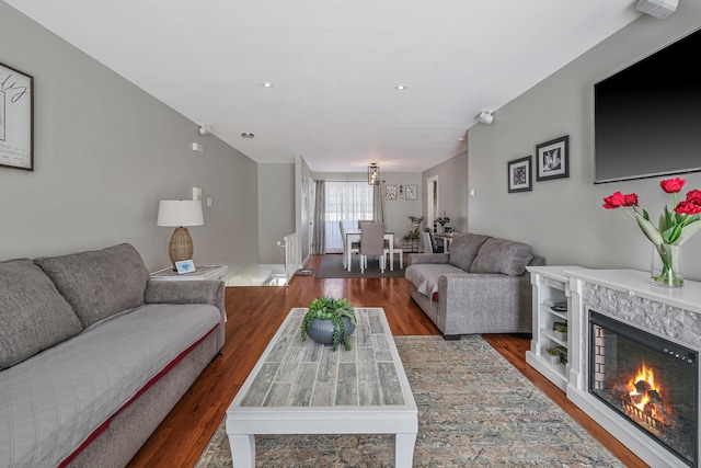 living room with a premium fireplace and hardwood / wood-style floors