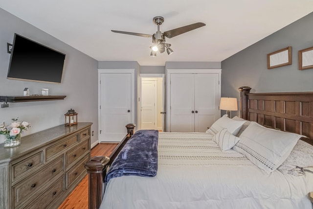 bedroom with light hardwood / wood-style floors, a closet, and ceiling fan