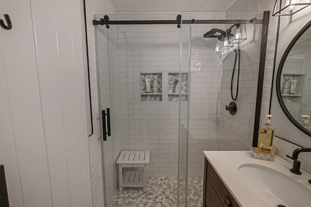 bathroom featuring vanity and an enclosed shower