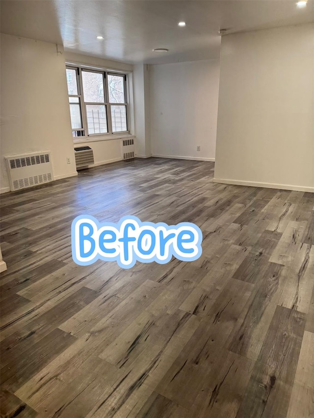 unfurnished room featuring radiator and dark hardwood / wood-style flooring