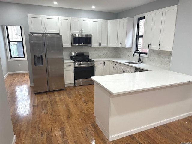 kitchen featuring white cabinetry, sink, and appliances with stainless steel finishes