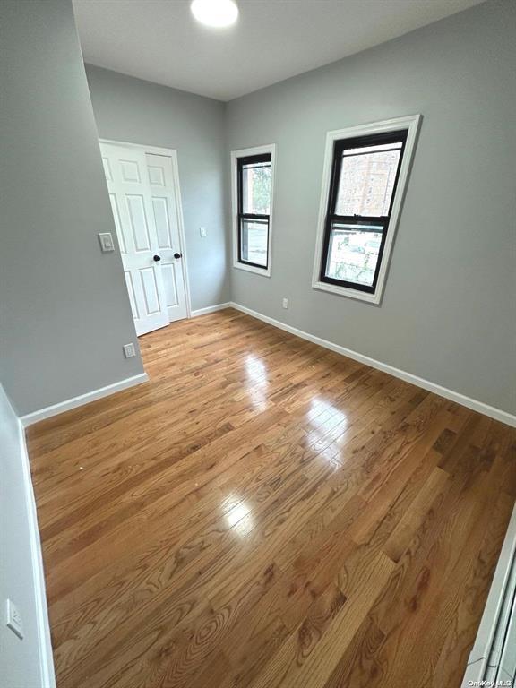 unfurnished room with light wood-type flooring